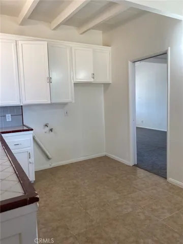 Kitchen, showing space for washer and dryer, or fridge.