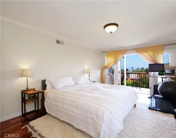 Primary suite bedroom with view balcony