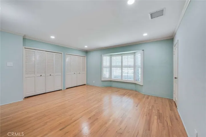 Spacious Primary Bedroom with Shutters and Double Closets