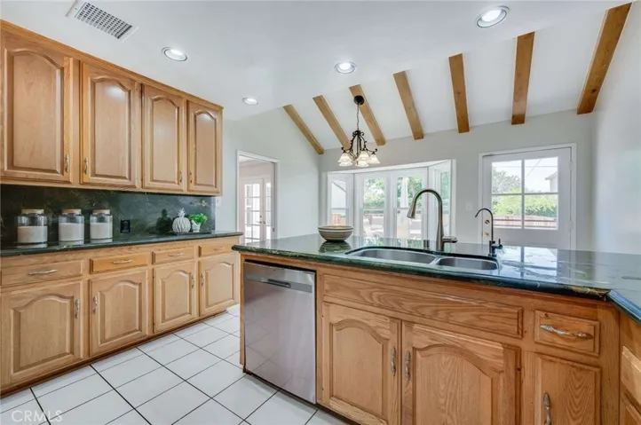 Light and Bright kitchen with plenty of counter top space and beamed ceilings