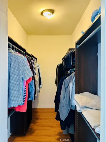 Walk-in closet inside primary bedroom