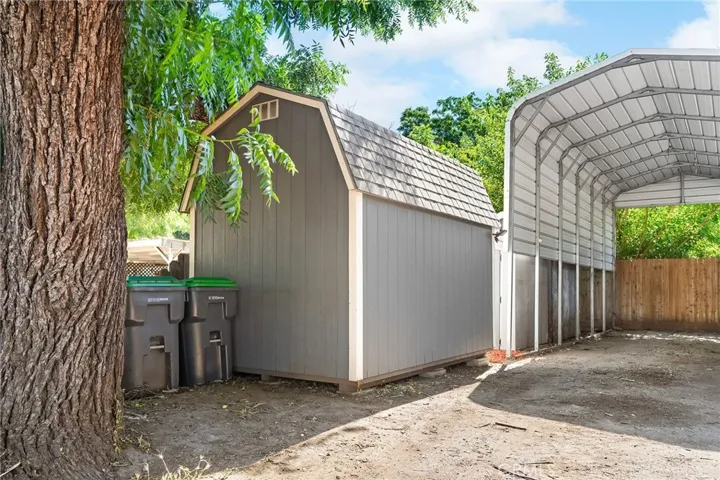 Three Storage Sheds and Cover RV Parking