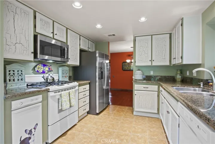 Kitchen with granite countertop and lots of cabinets