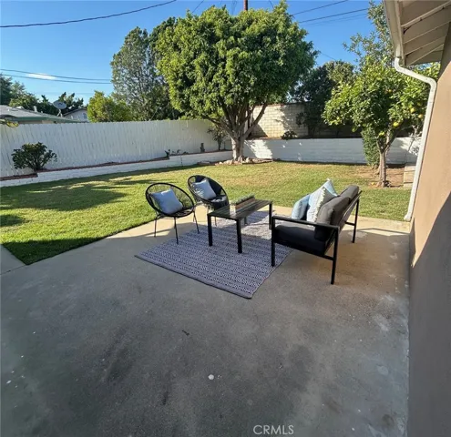 Generous and private back yard with patio, Citrus trees, and large lawn area