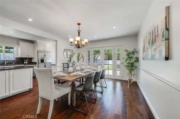 Hardwood floors grace this sizable Formal Dining Room that looks into the kitchen