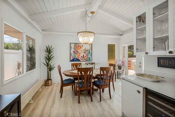 Enter the Dining area which includes a Dry Bar area with wine refrigerator. No other home in the Knolls was built with this additional room. These are the ORIGINAL Bottle Glass windows from that era!