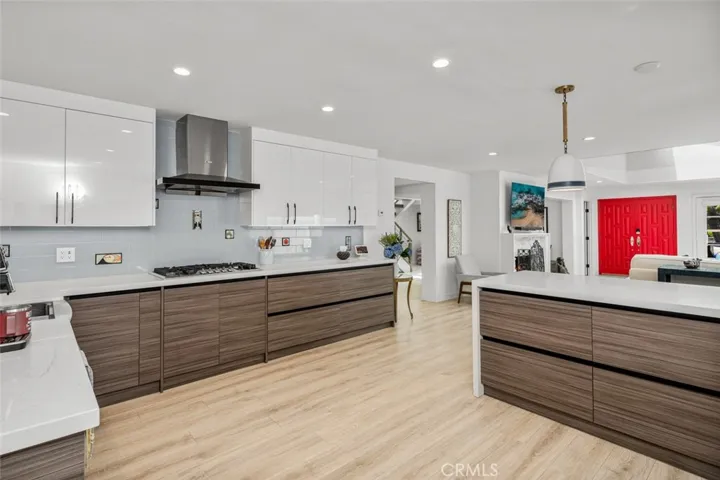 The Kitchen is completely new from the slab up. A wall was removed from the space where the counter crosses the room creating a very usable space for multiple cooks! All newer cabinets, appliances, countertops & lighting.