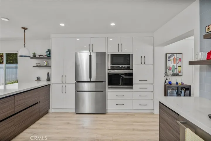 The appliance wall includes the Bosch Refrigerator, GE Profile Oven, Convection oven & behind the storage caddie. The Dishwasher is also Bosch.