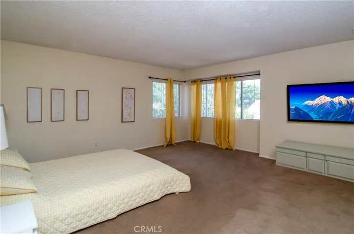 Primary bedroom / artwork is virtually staged