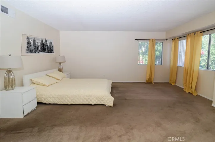 Primary bedroom / artwork is virtually staged