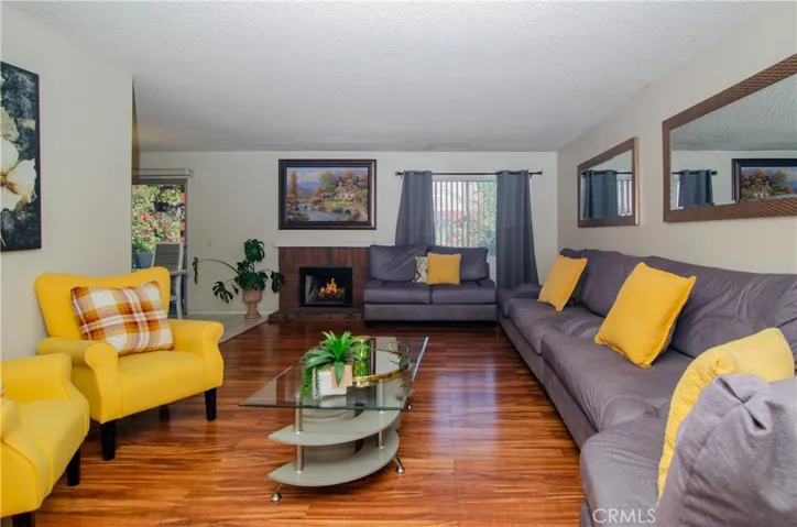 Living area / flames virtually staged inside fireplace hearth.