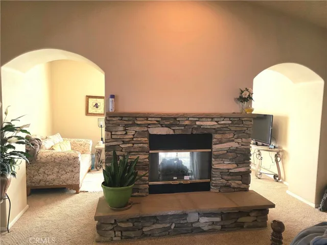 View of primary retreat area and see-through fireplace.