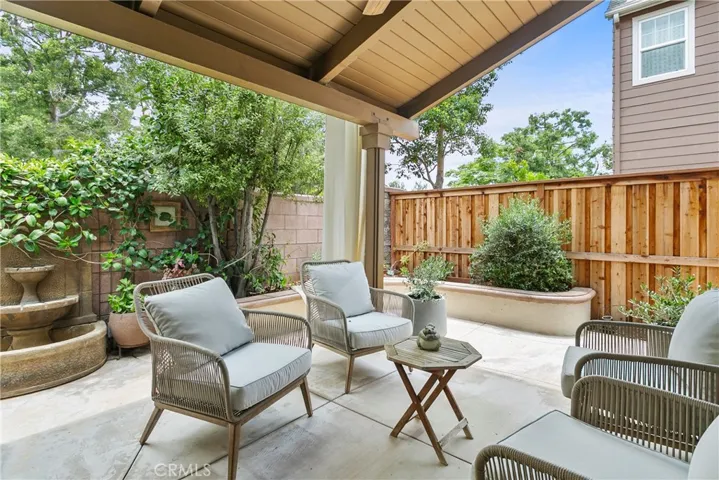 Serene patio with water feature and comfortable seating, 
 perfect for relaxing or entertaining