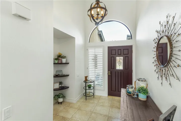 Airy entry with powder room to the left in the photo