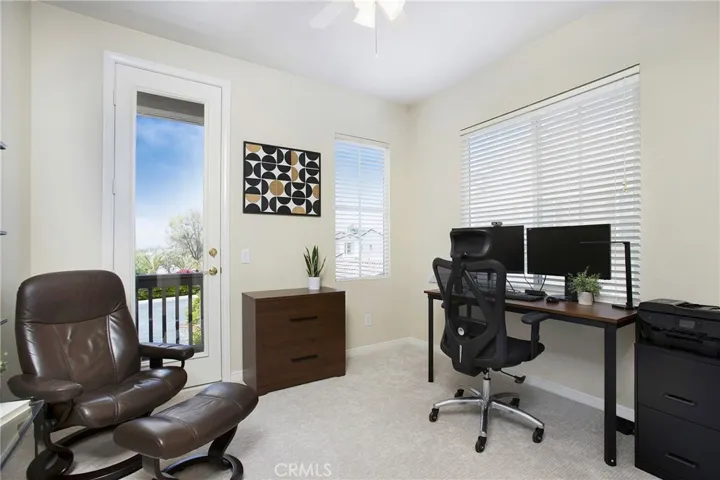 Secondary bedroom being used as an office - opens to balcony with more views