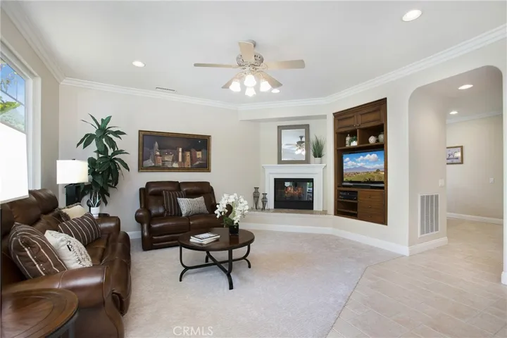Built in entertainment center and fireplace with mantel, surround and raised hearth