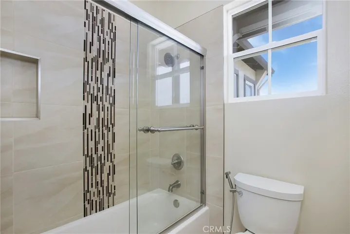 Secondary tub/shower surround with designer details and frameless glass doors