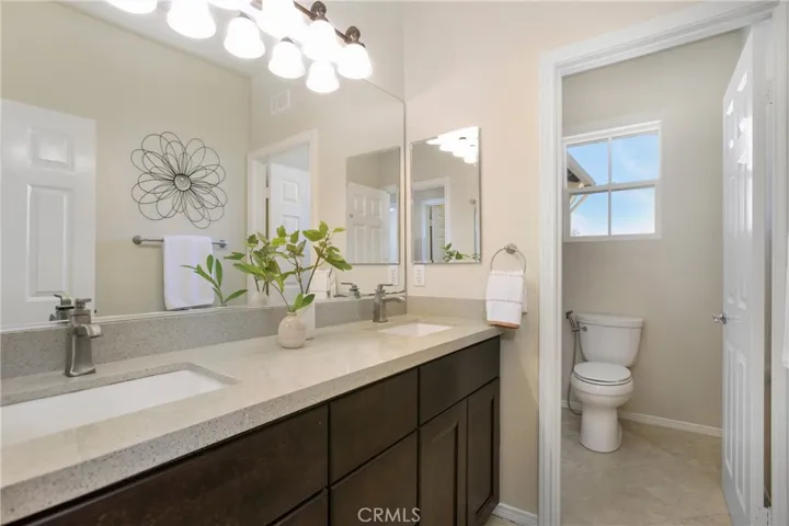 remodeled secondary bathroom with quartz countertops