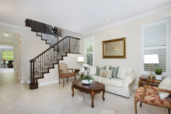 Stunning iron staircase, stone flooring, crown moulding and shutters