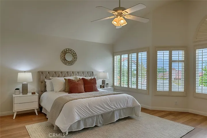 Primary bedroom with plantation shutters & view of the hills