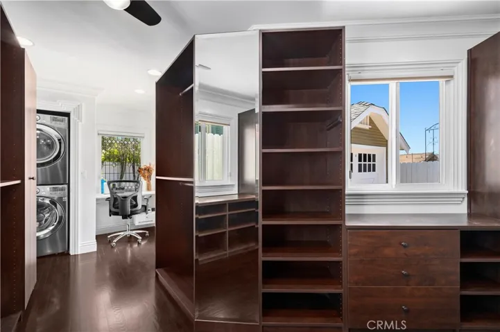 A spacious adjacent room with a built-in closet, laundry, and office space.