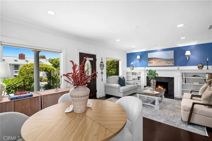 Features two bedrooms, one and a half baths, a den, and classic wood flooring throughout.