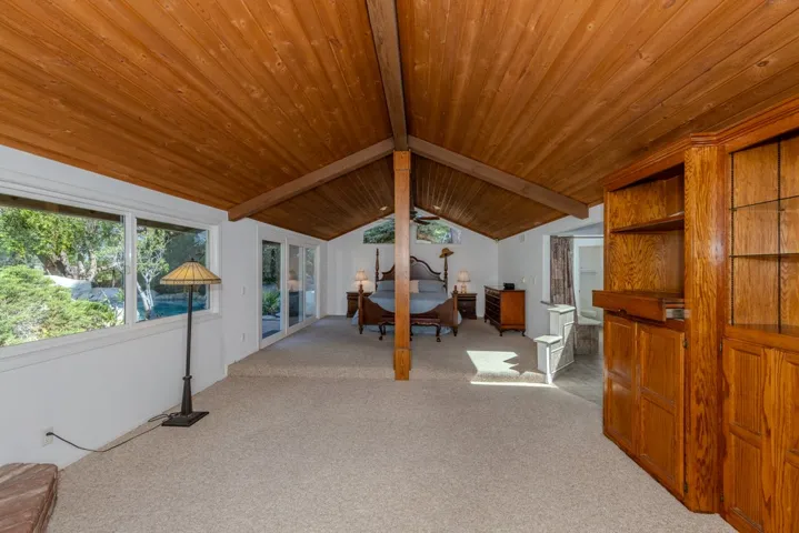 Entering the dramatic and spacious primary suite.  Note the many built-in cabinets and separate living area
