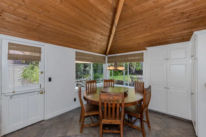 eating area in kitchen has spacious built-in pantries and dramatic soaring ceiling (note Dutch door to west side yard on left)
