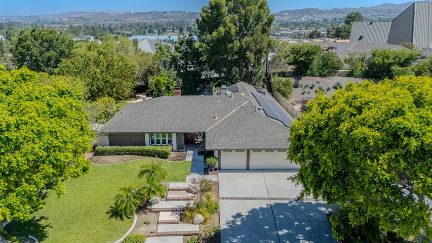 Front, drone shot; giant tree in middle of this photo is in this property's backyard!