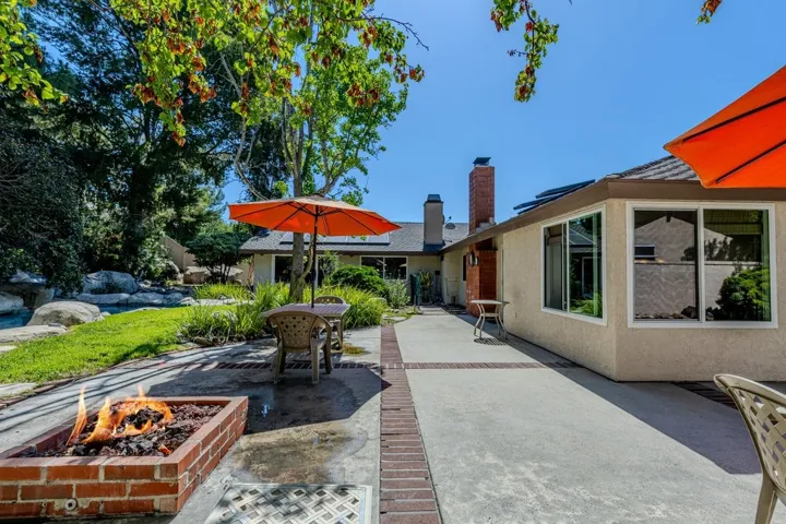 backyard features gas firepit (pool just off to left)