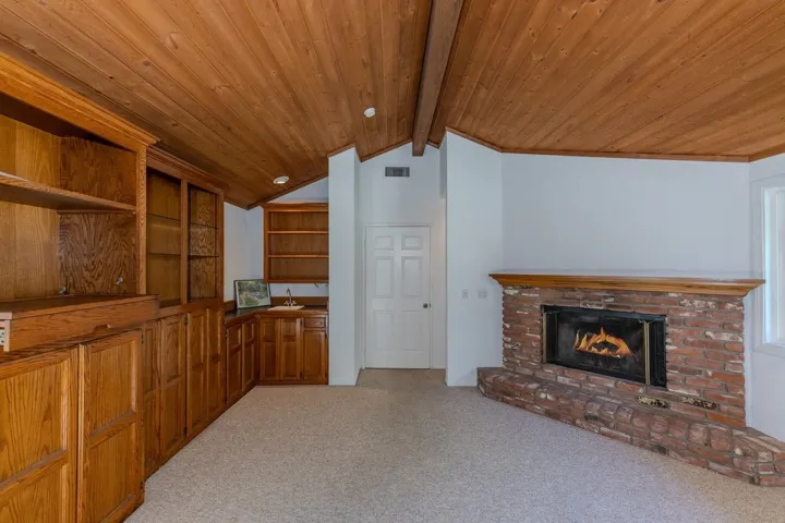 Primary suite sitting area (viewed from bed area) boasts 2nd gas brick fireplace