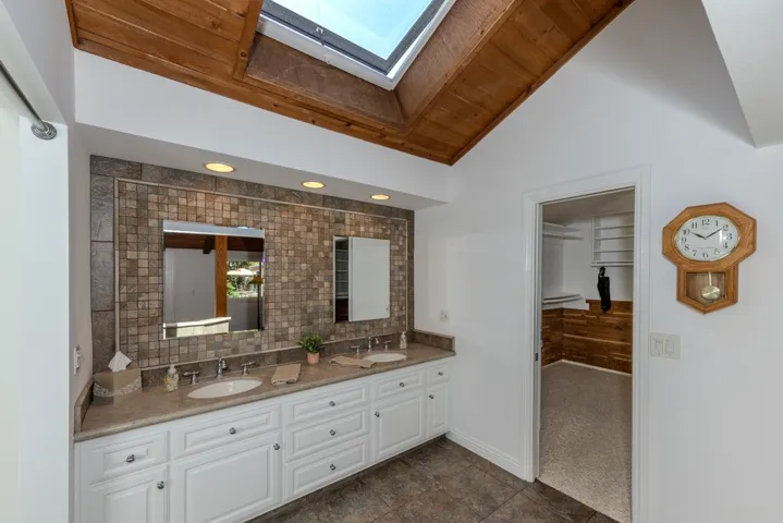 primary ensuite bath area looking toward walk-in closet from bed area