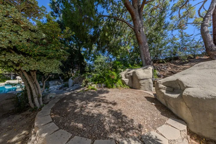 trampoline area east of pool, NE corner of lot behind primary bathroom, between spa path and hidden storage caves