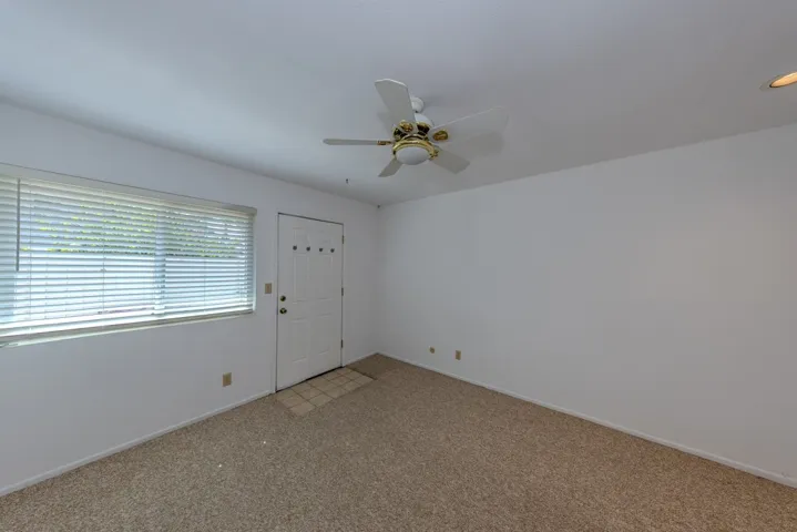 (bdrm 3) near laundry room, from doorway (features separate entry from outside, shown here).  Seller used this as 3rd bdrm; prior owner had used it as office since closet doors were removed and built-in wood bookshelves were installed
