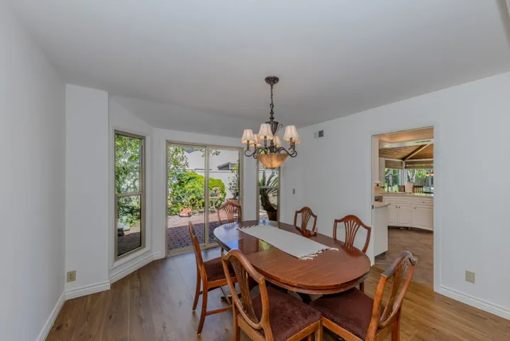 formal dining room with bay windows and slider (doorway into kitchen at right is a pocket door)