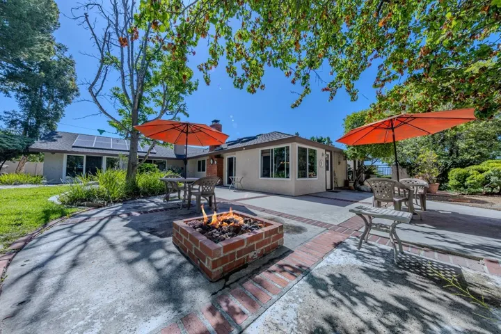 backyard gas firepit looking towards kitchen dining area (pool is just to the left)