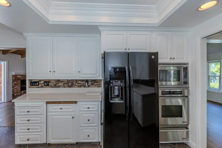 kitchen opposite 6-burner Thor cooktop; note Dacor Convection oven, regular oven and warming drawer on the right; ; rolling butcherblock island to left of fridge (refrigerator included)