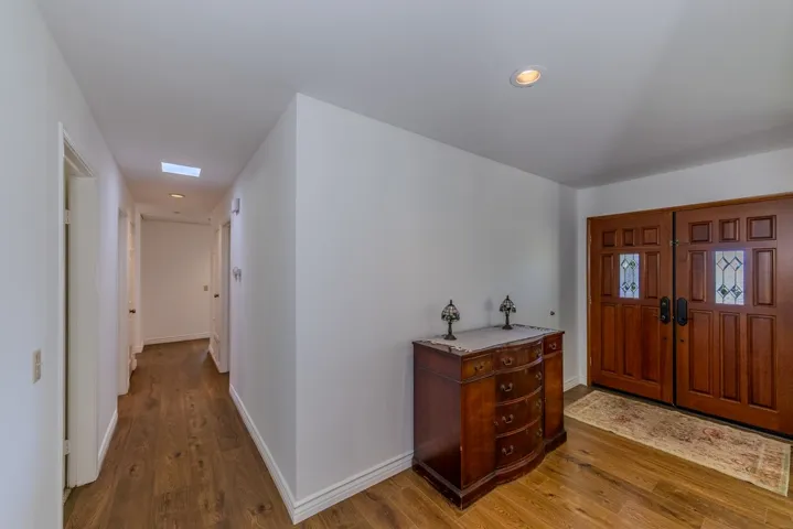 Entry looking SE towards bedroom areas; note hallway mini-skylights (and pulldown attic access at end of hall)