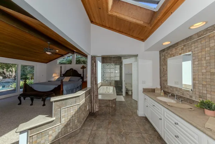 Primary ensuite bath area looking into separate room for shower + bath; as viewed from walk-in closet