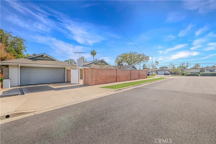 This lot location is unique!! Look at all this parking you have on the side of the house.
Garage entry from side street. Block walls with gated entry to backyard.