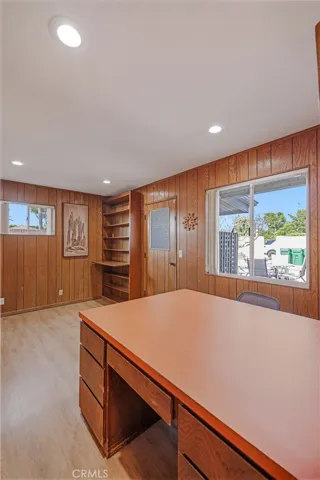 Office with built-in large desk and shelves. Could be a bedroom if you needed an extra bedroom. Door takes you to backyard!
