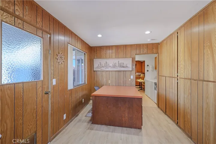 Door exits to backyard. Large desk and lots of storage!