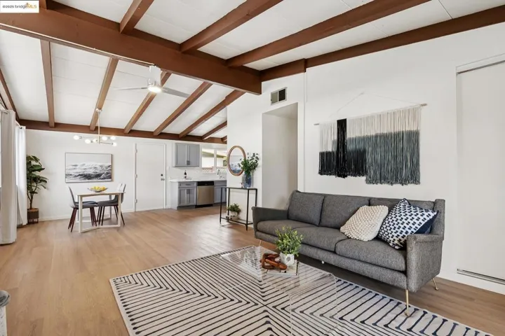 Cozy living room with exposed beam ceiling and a classic brick fireplace
