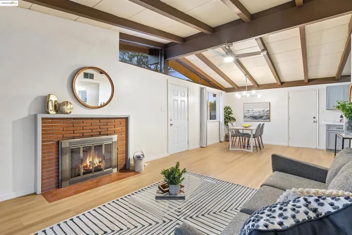 Cozy living room with exposed beam ceiling and a classic brick fireplace