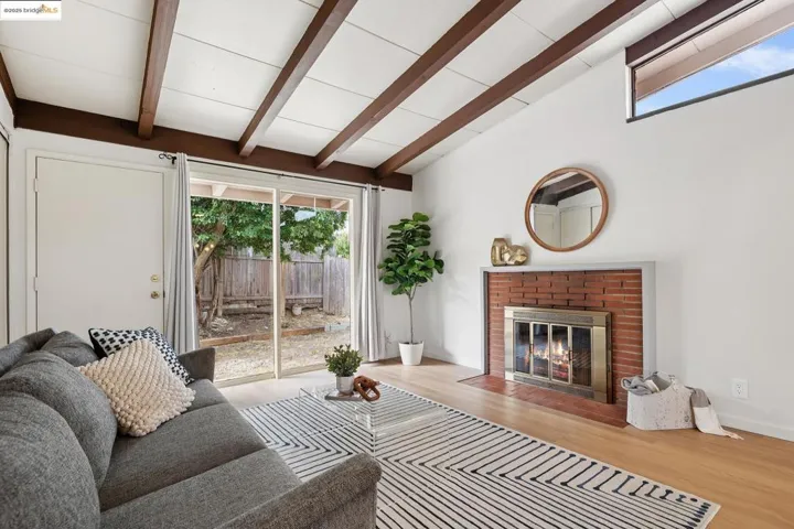 Cozy living room with exposed beam ceiling and a classic brick fireplace