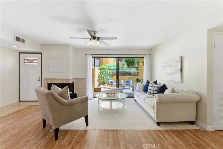 Light and bright living area with rear patio and yard access