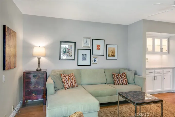 Another view of family room including quartz counterspace, glass cabinets and storage cabinets and drawers.