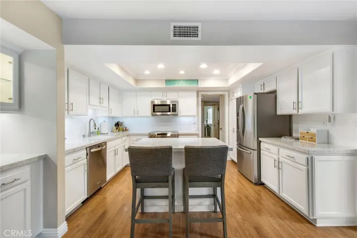 View from family room to kitchen including small island.