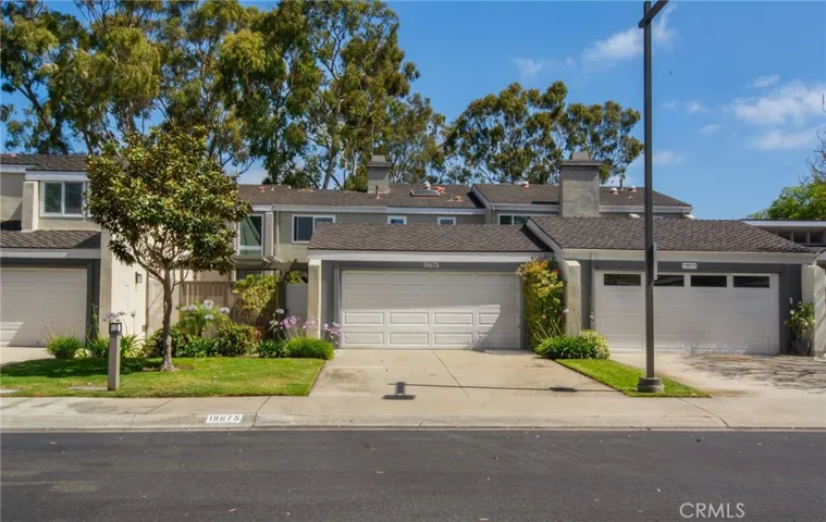 Front view of home including 2 car garage and side gate door entry.