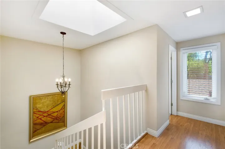 Upstairs hallway including stairwell skylight.